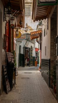 Explore a sunlit alley in Tangier's historic medina, featuring traditional Moroccan architecture.