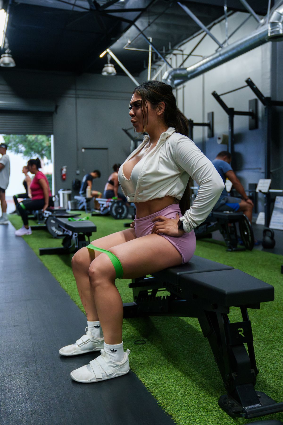 Athlete performing resistance band training in a modern fitness studio
