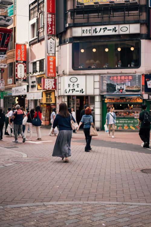 Free A busy street in Shibuya, Tokyo, with pedestrians and iconic Japanese storefronts. Stock Photo