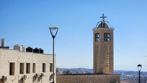 Free Scenic view of a stone building and tower under a clear blue sky in Palestine. Stock Photo