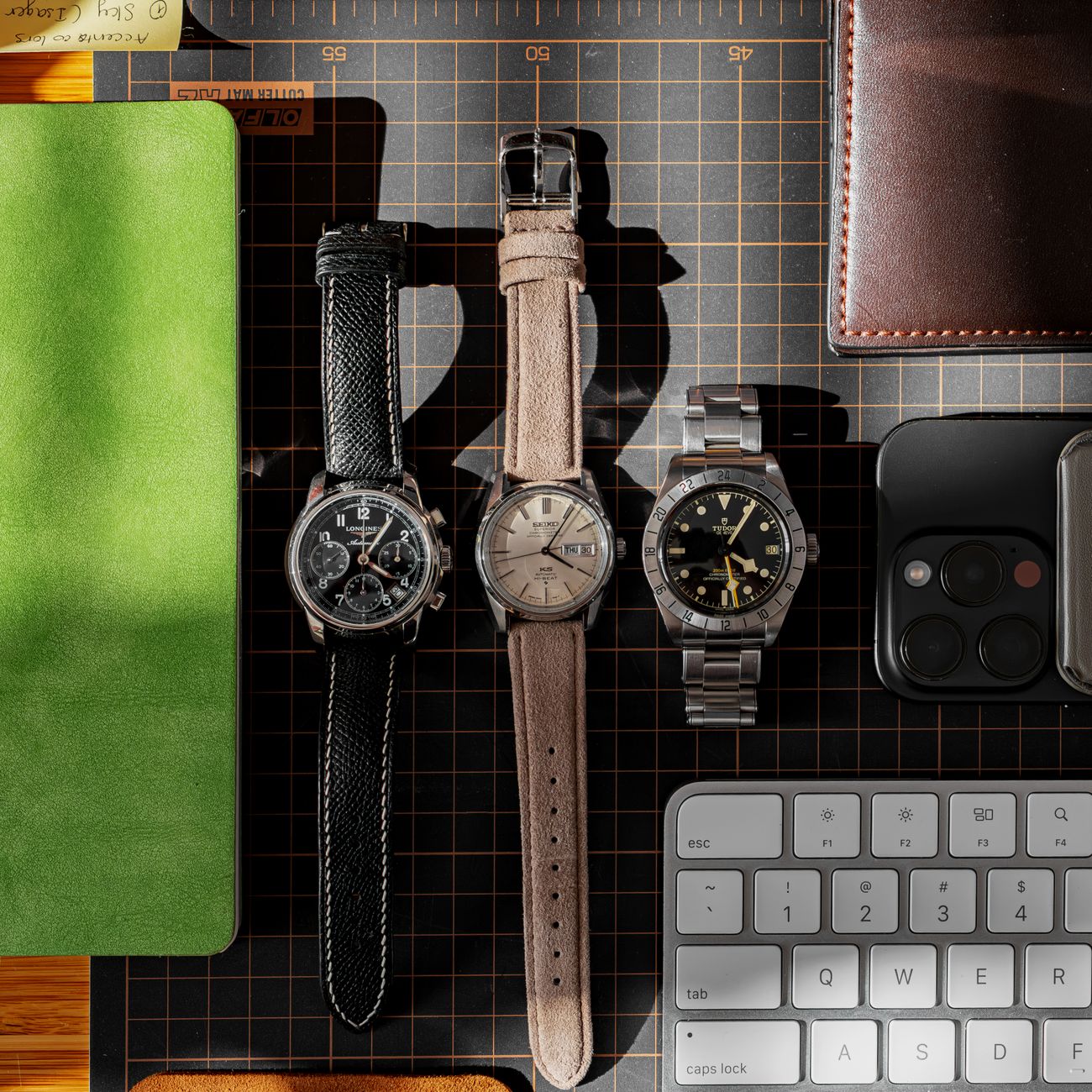 Stylish watch collection displayed in a modern workspace setting with accessories.