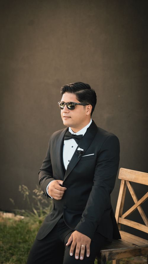 Free Elegant groom in a black tuxedo posing outdoors with sunglasses in Ankara, Turkey. Stock Photo
