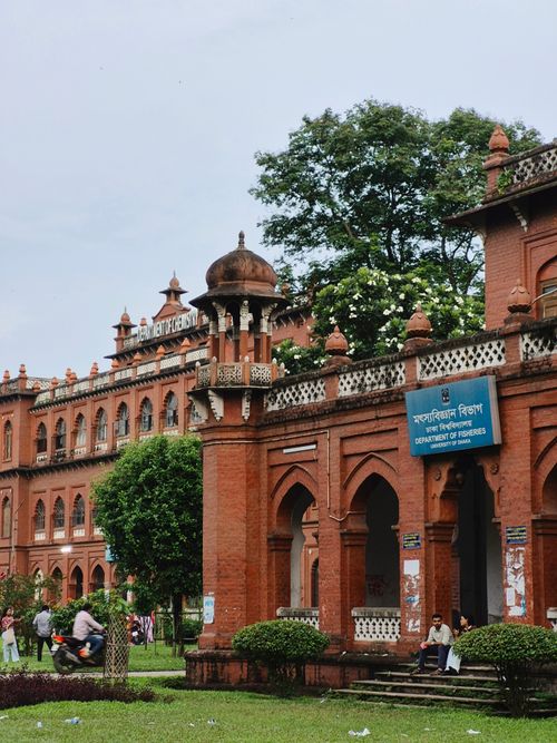 Free A historic red brick building with ornate architecture on a university campus. Stock Photo