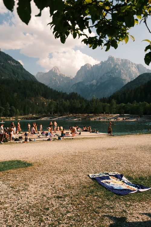 Free People enjoying a sunny day at a mountain lake with stunning views. Stock Photo