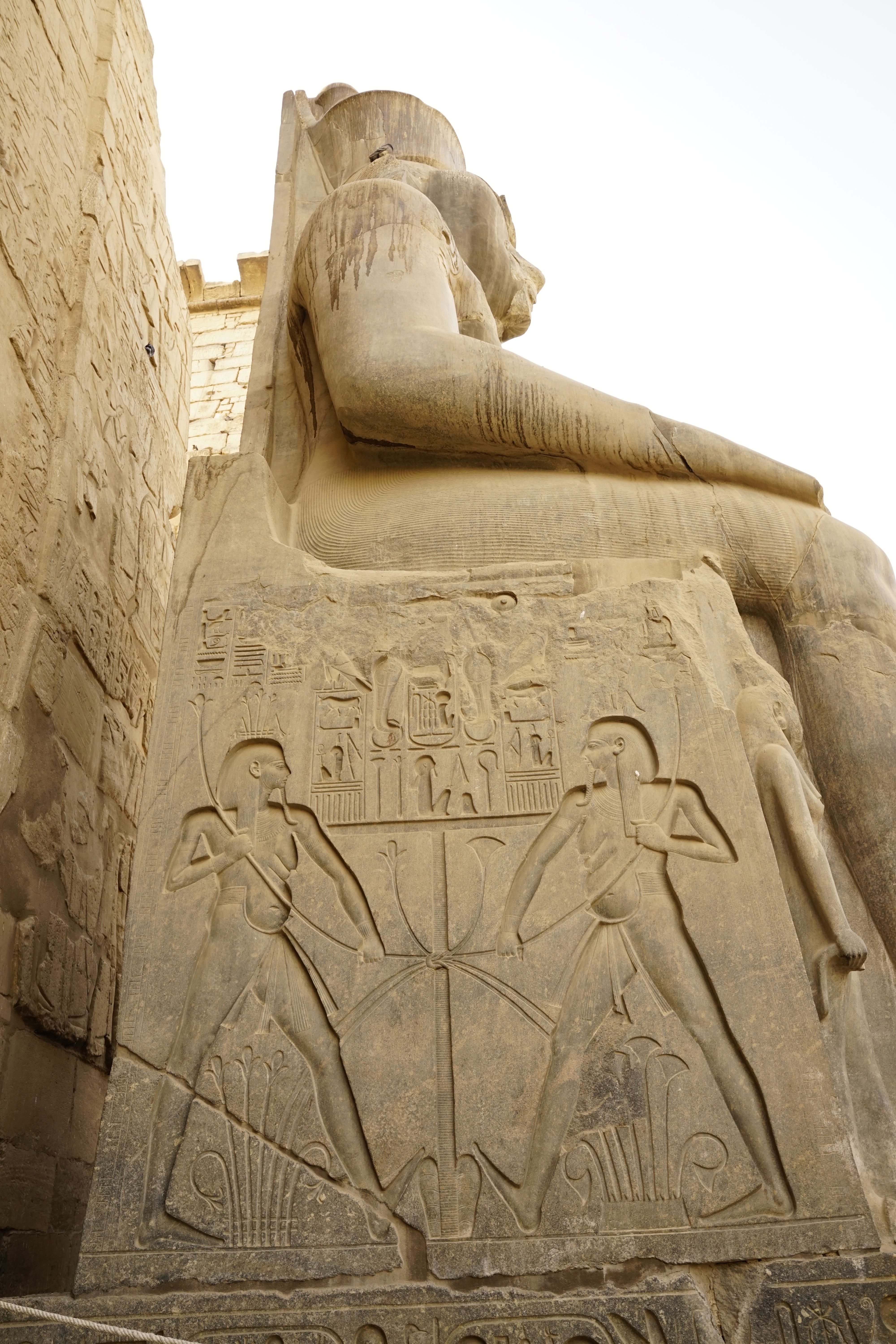 Close-up of a monumental stone statue with hieroglyphics in Luxor Temple, Egypt.
