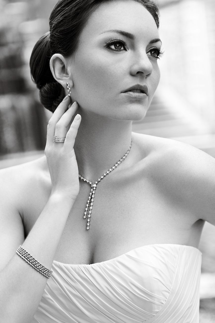 Black and white portrait of an elegant woman in bridal attire with jewelry