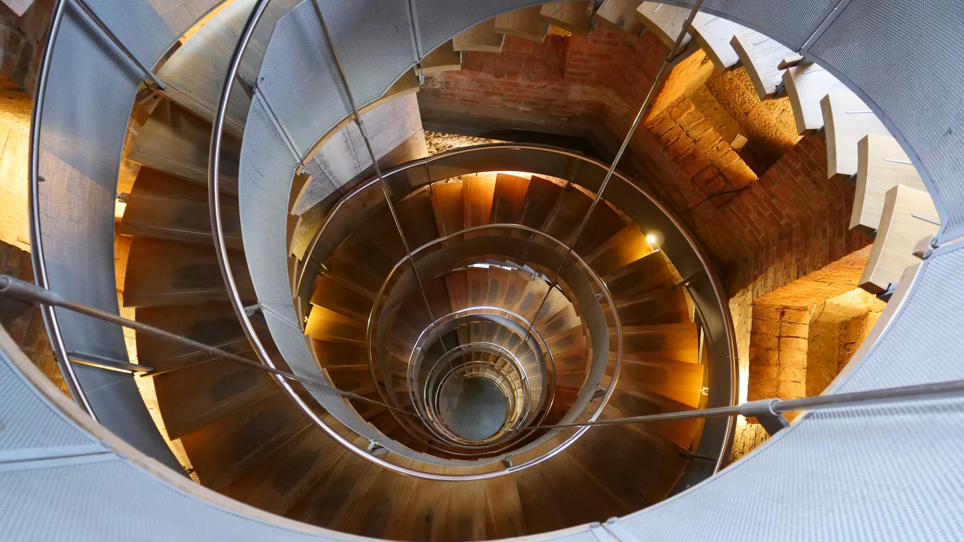 Dynamic view of a spiral staircase inside a Glasgow architectural marvel.