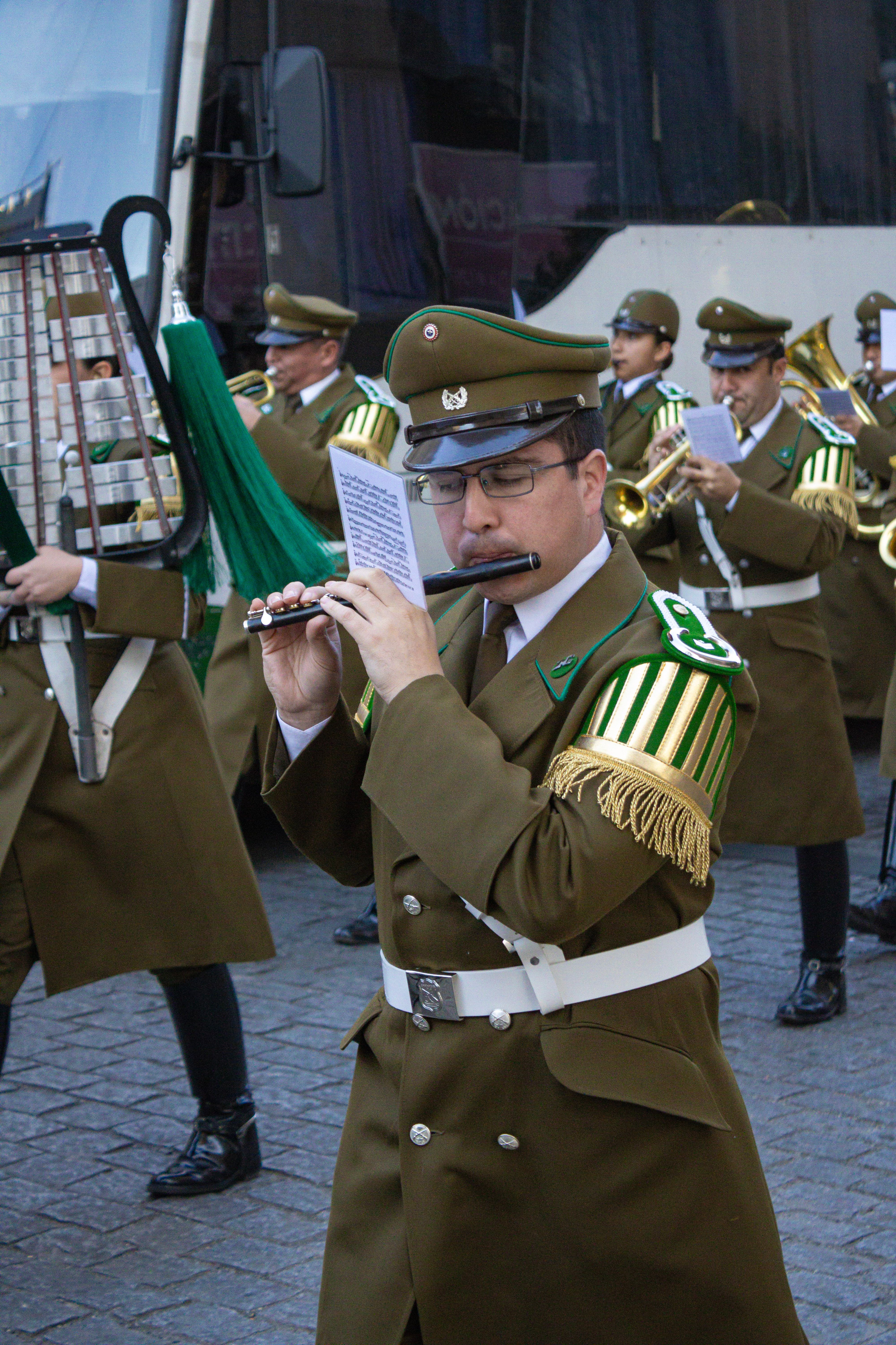 Chilean military musicians perform in uniform during a parade in Santiago.
