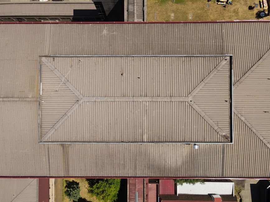 Aerial photograph of a large building's rooftop displaying unique architectural patterns.