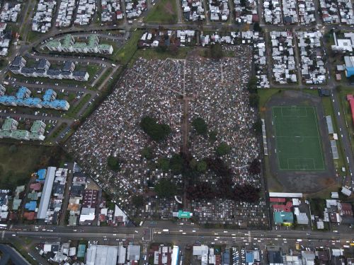 Free Aerial photograph capturing a cityscape with a cemetery and adjacent football field in Valdivia, Chile. Stock Photo