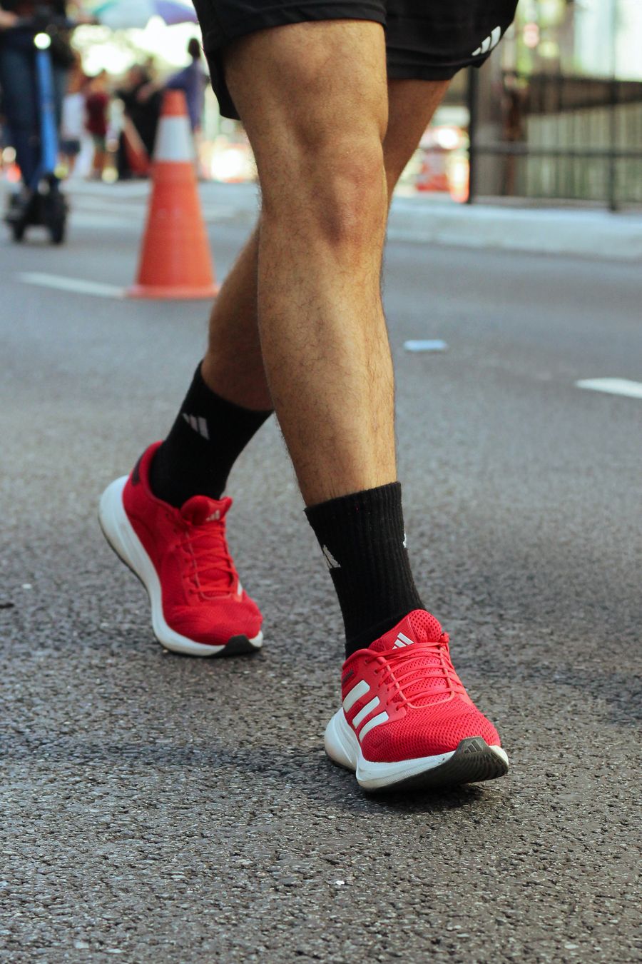 Runner's legs mid-stride on a city street
