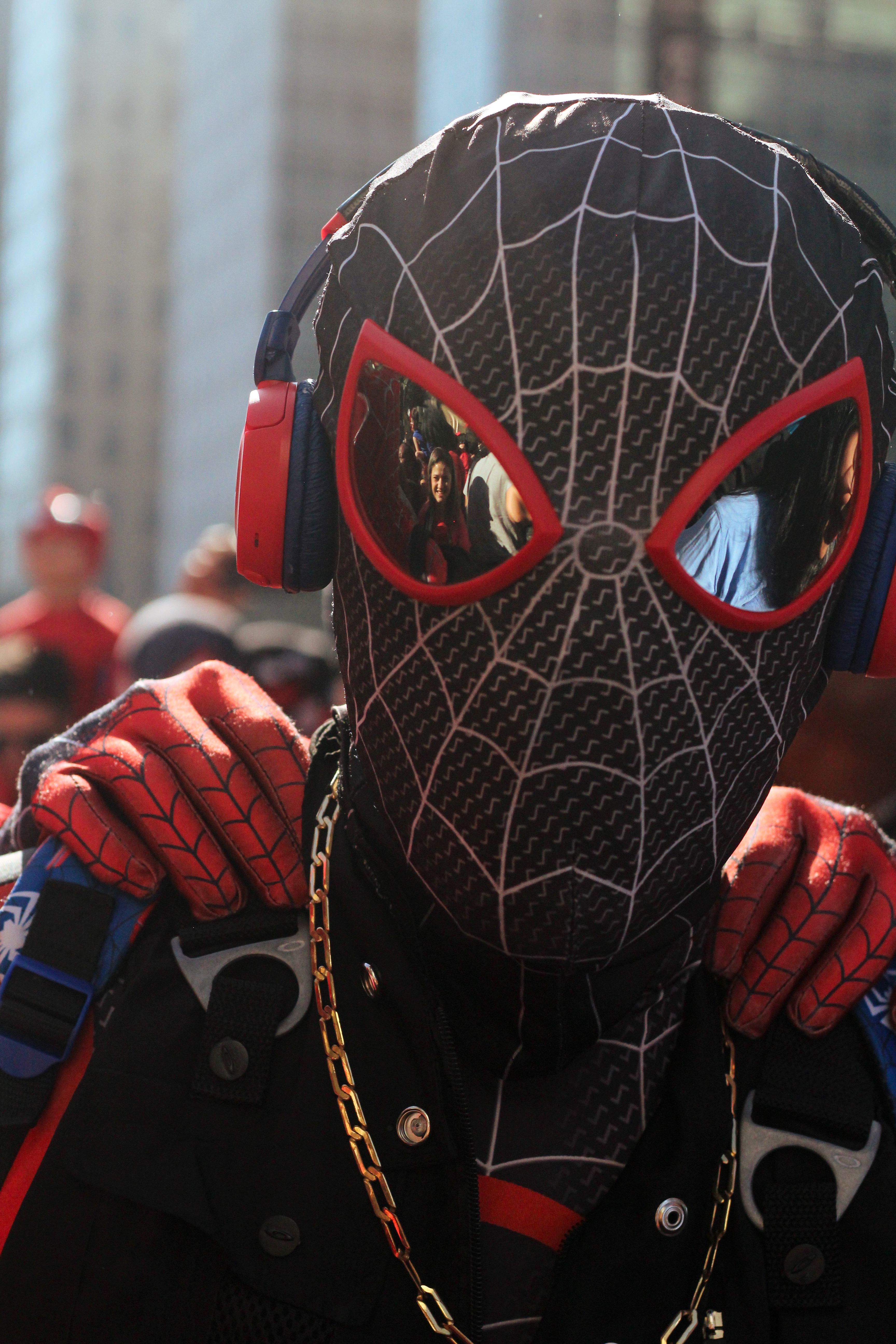 Spider-Man cosplayer with headphones at a street event in São Paulo, Brasil.