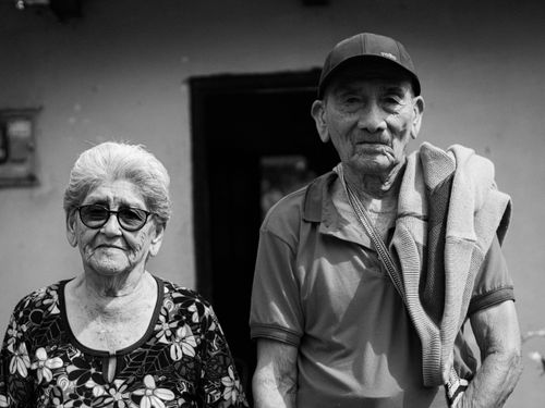 Free Black and white portrait of a senior couple standing outside their home in Gigante, Colombia. Stock Photo