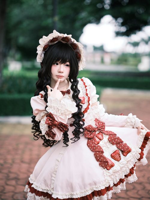 Free Charming portrait of a young woman in Victorian-inspired Lolita fashion, posing outdoors. Stock Photo