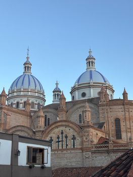 A captivating image showcasing the iconic blue domes of Cuenca's New Cathedral against a clear sky.