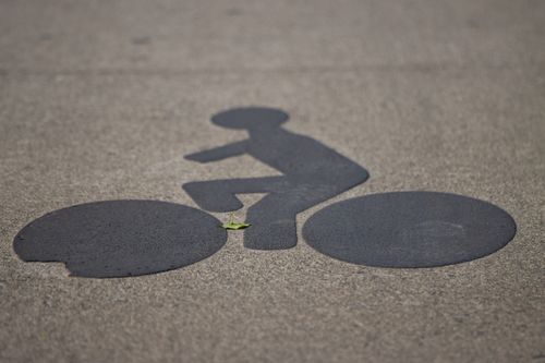 Free Cyclist symbol on road indicating a bicycle lane in Saint-Malo, Brittany, France. Stock Photo