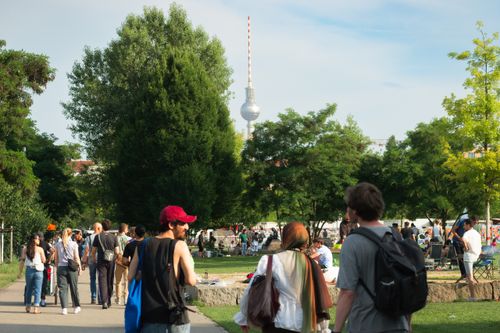 Free Crowds in a Berlin park enjoying a sunny summer day with the TV Tower nearby. Stock Photo