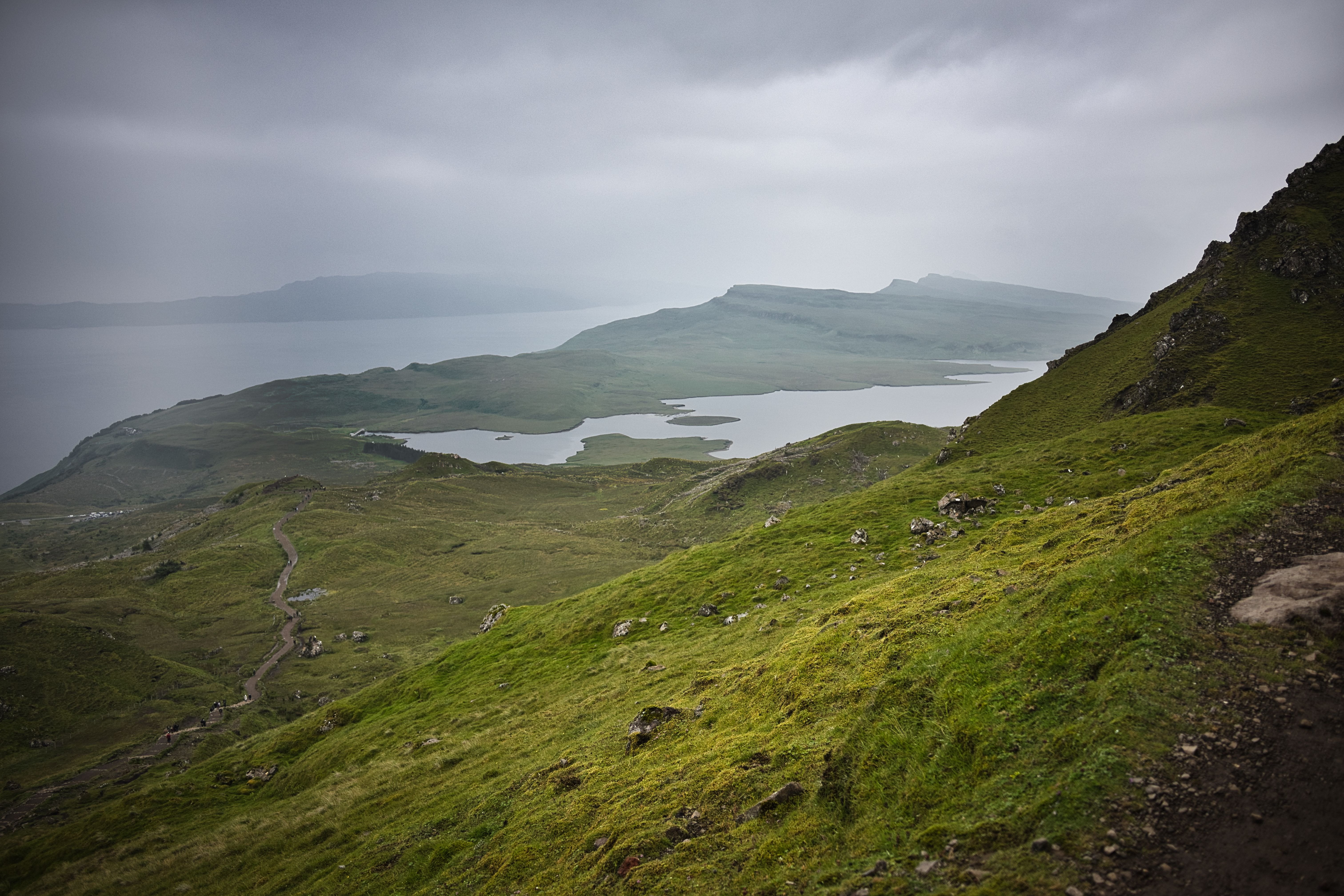 Moody and scenic view of the Scottish Highlands with lush green hills and serene waters. — photo by Dominik Gryzbon / Pexels