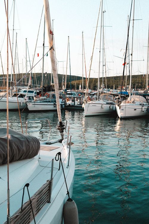 Free Calm harbor scene with moored sailboats at Sığacık, İzmir, showcasing a peaceful summer day. Stock Photo