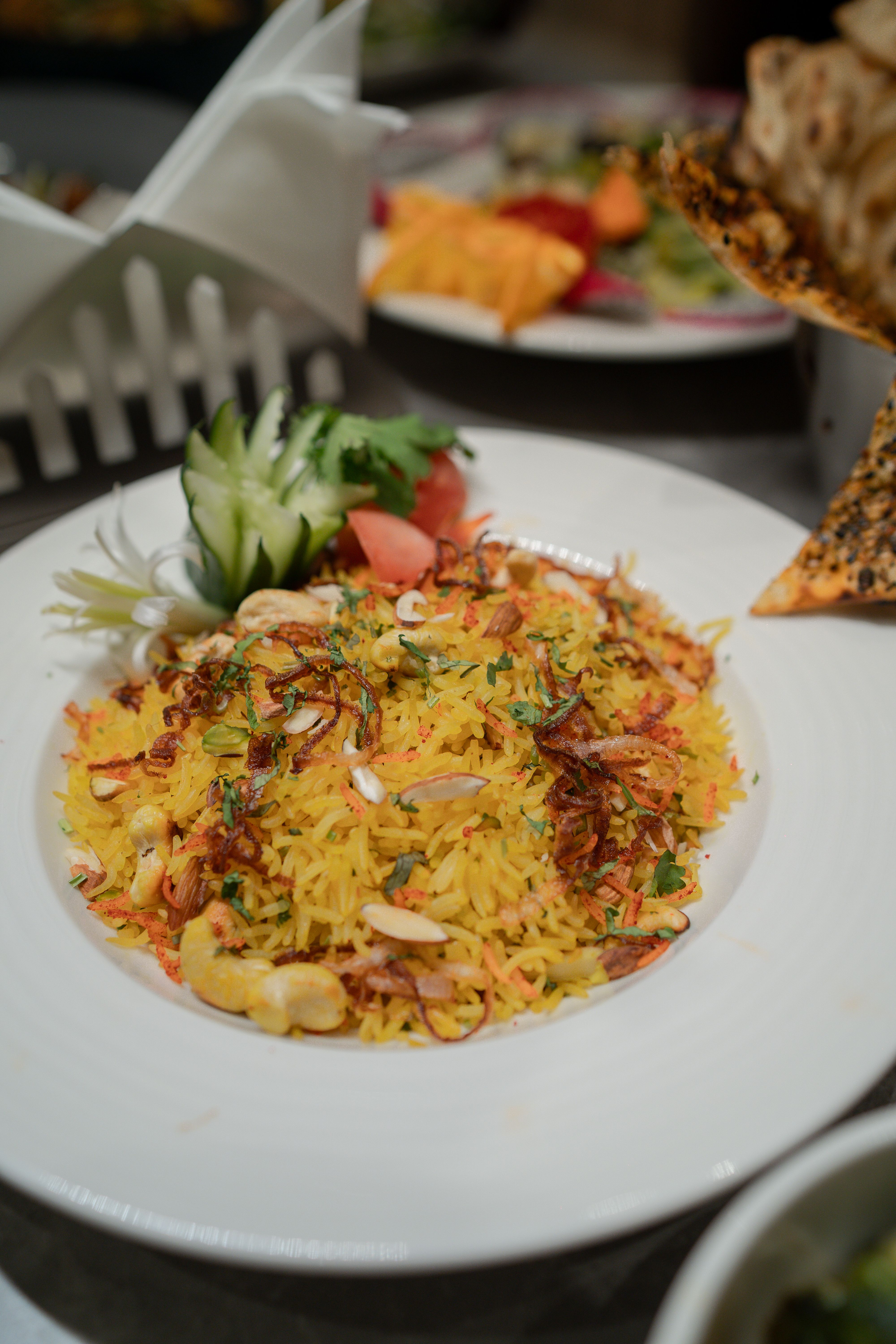 Layered biryani rice served with raita