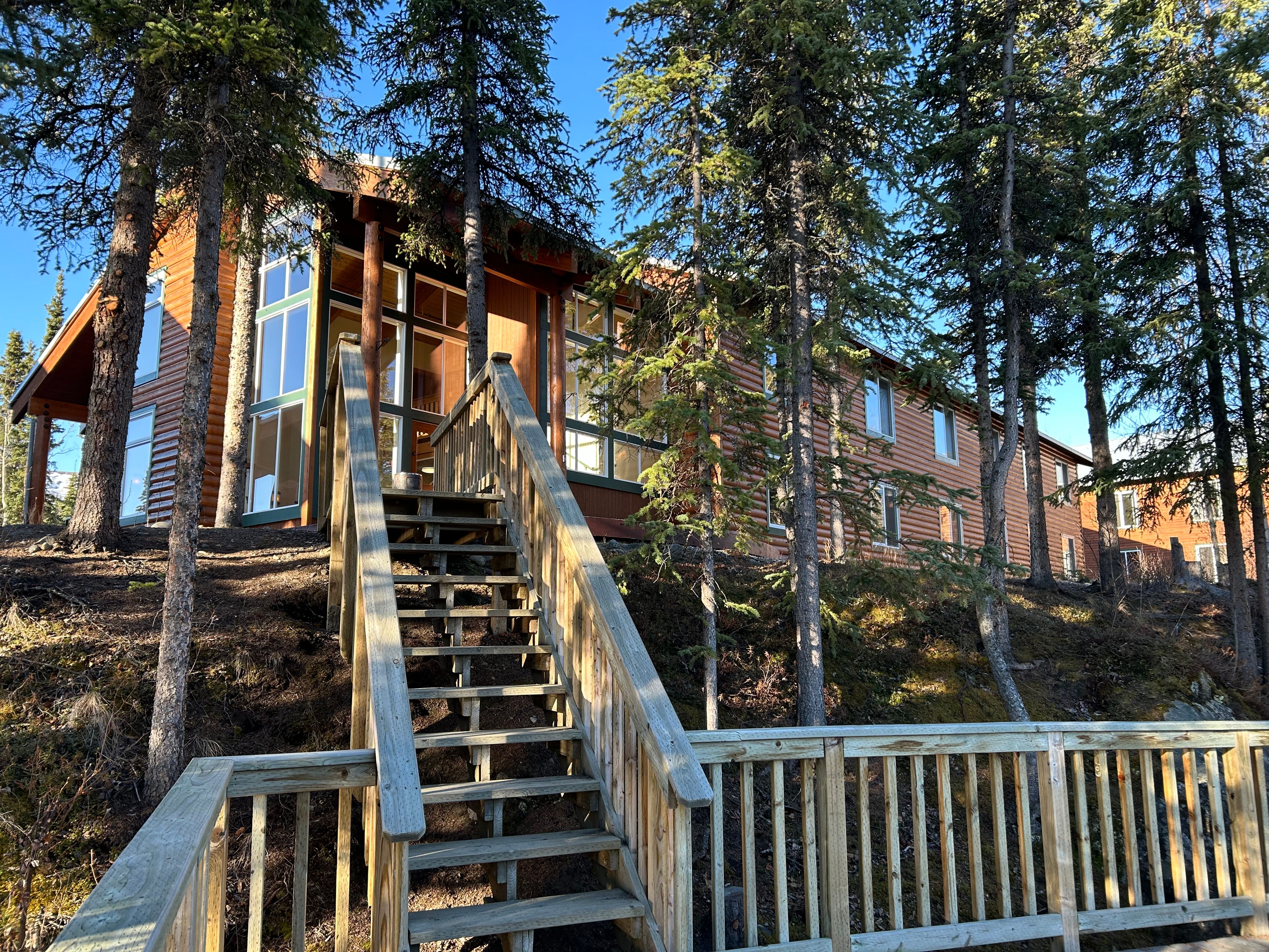Rustic cabin with a timber stair — photo by Lunar Bloc on Pexels