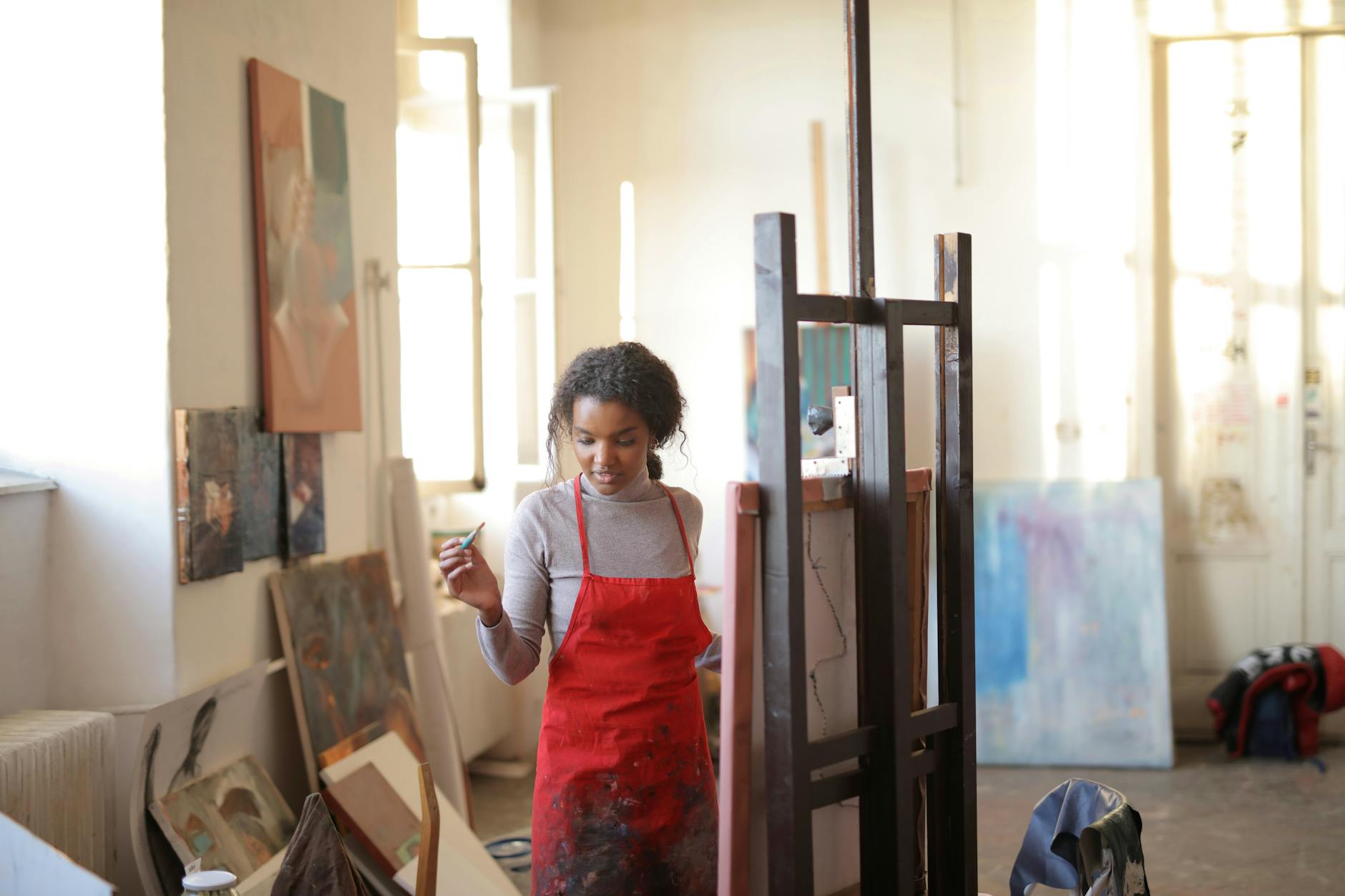 Female artist painting in a studio. Digital detox