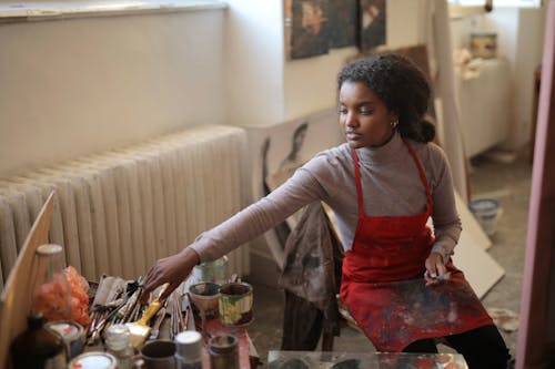 Young female artist working in studio