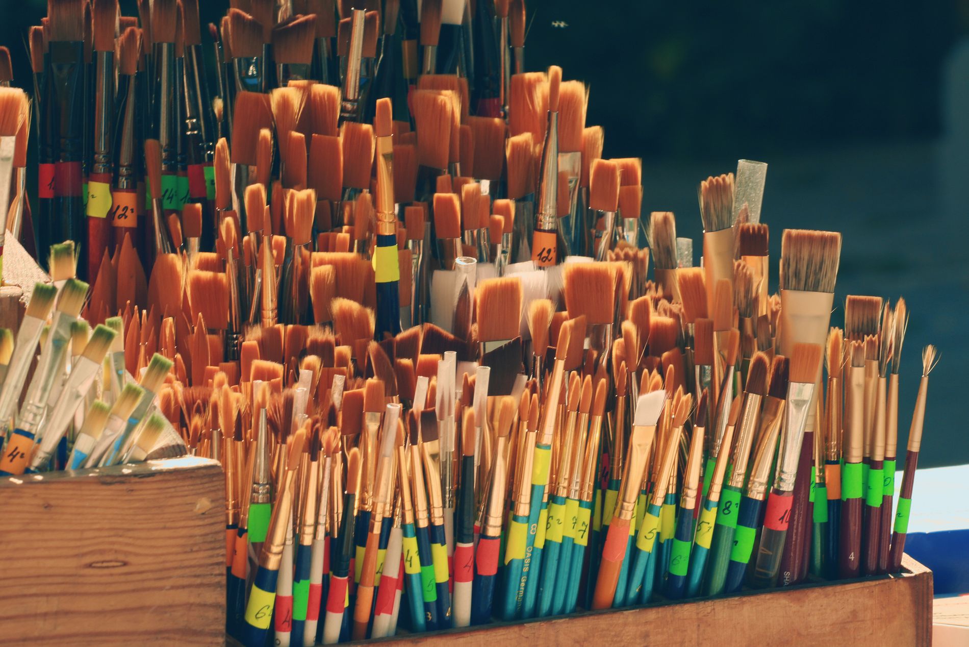 Rows of finished brushes standing in a wooden drying rack at the works