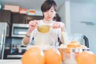 A Woman Holding a Strainer