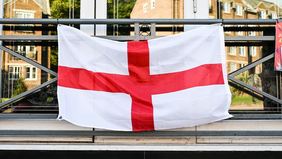 A St George's Cross flag hanging from a railing