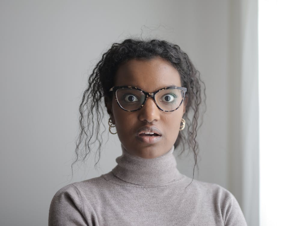 Surprised ethnic woman looking at camera