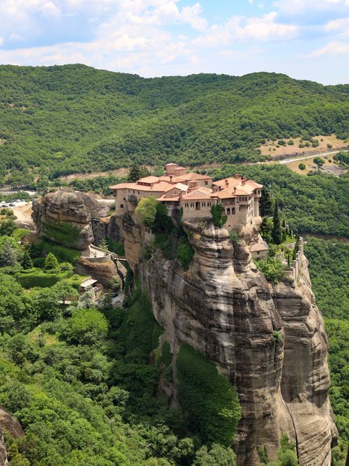 Free Stunning aerial view of Meteora Monastery in Grecia, surrounded by lush greenery and rocky cliffs. Stock Photo