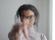 Young ethnic woman pointing at camera