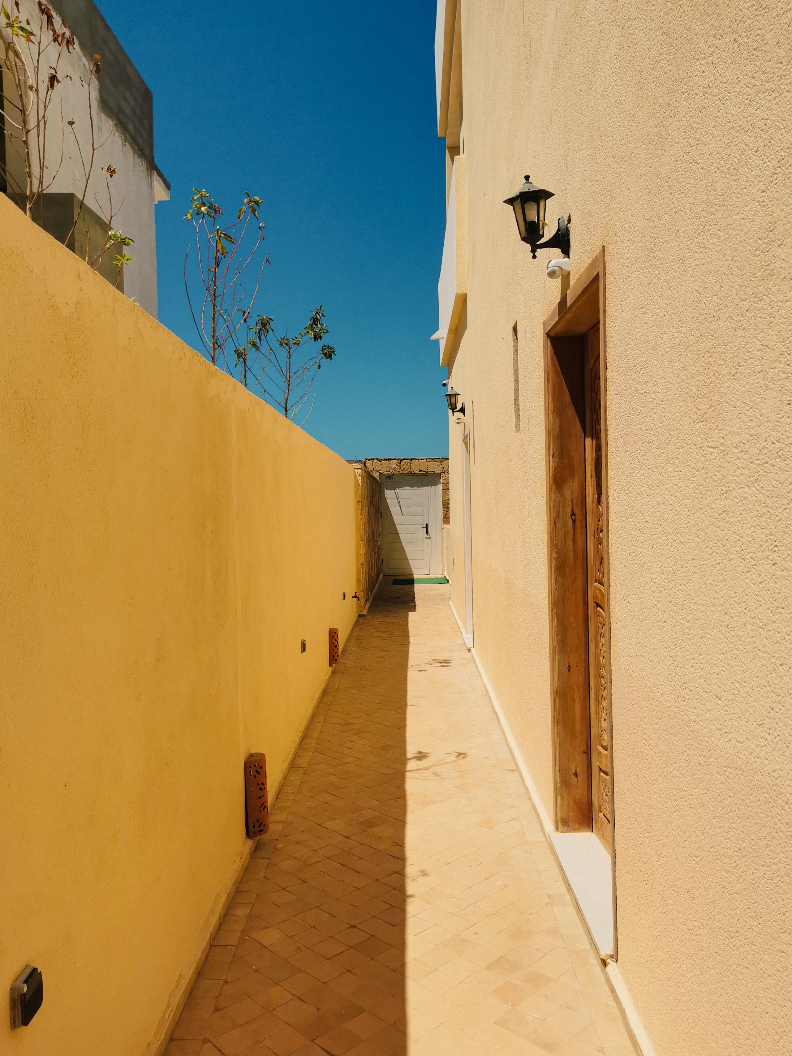 A bright yellow alley with doors and blue sky in Oued Ed-Dahab-Lagouira.