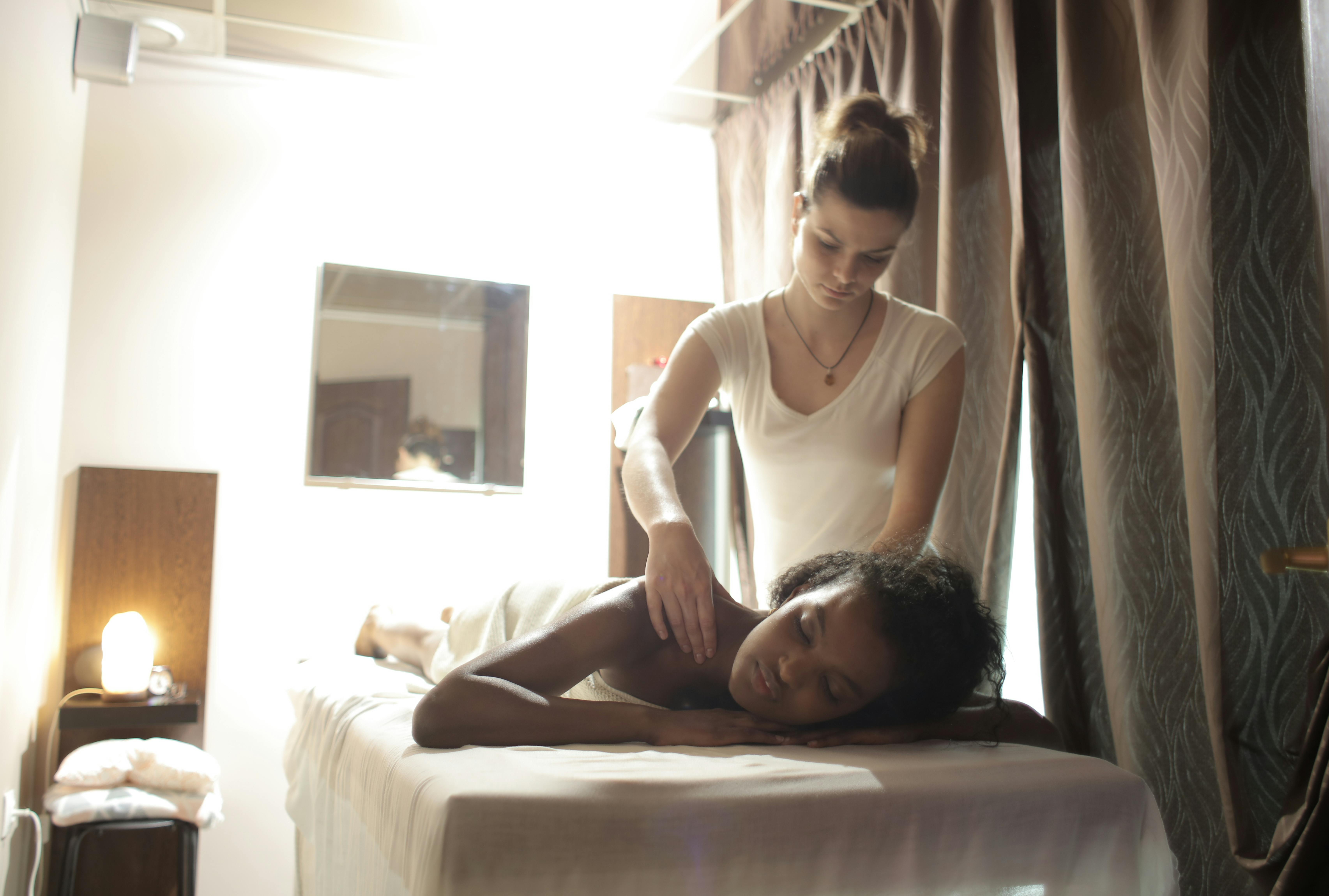 woman lying down in bed for a massage