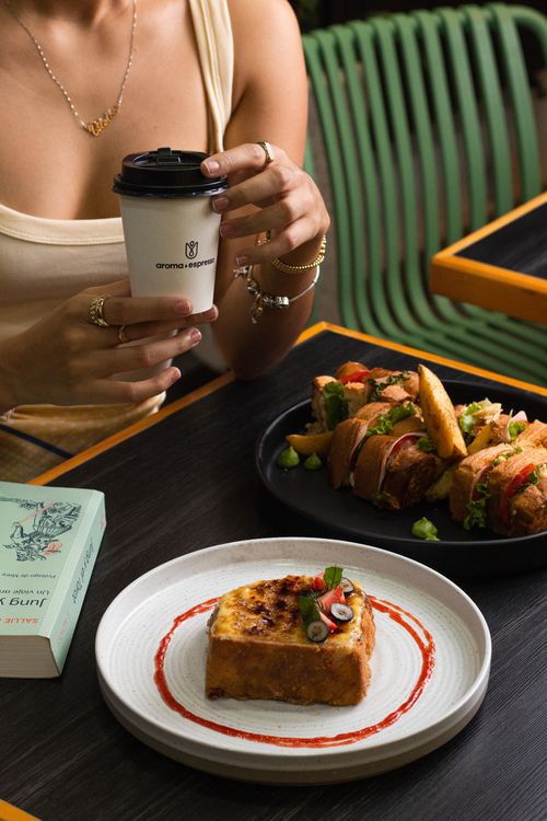 Free A vibrant café setting featuring coffee, sandwiches, and dessert in Chiapas, México. Stock Photo
