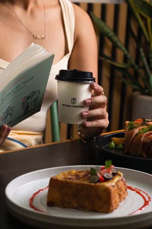 Free Cozy café setting in Chiapas with coffee, food, and a book, capturing a warm atmosphere. Stock Photo