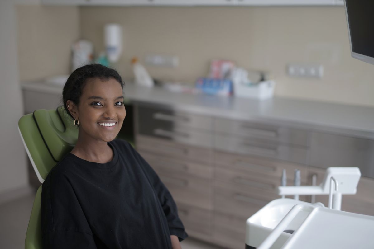Relaxed female patient smiling after a comfortable dental implant appointment
