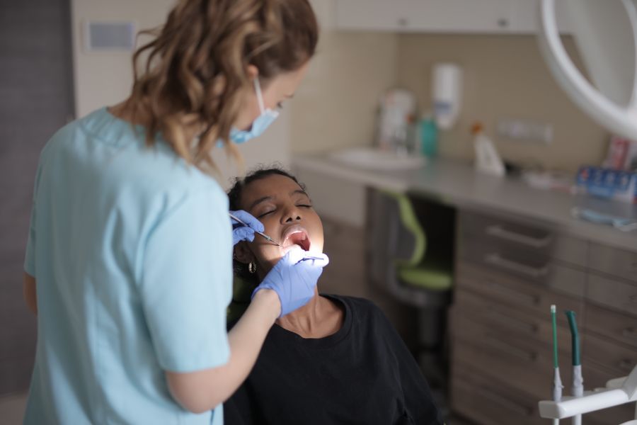 Female dentist providing a careful dental check-up