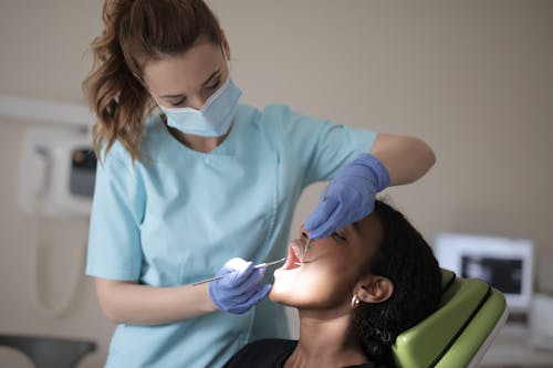 Free A Dentist Checking On Her Patient Stock Photo