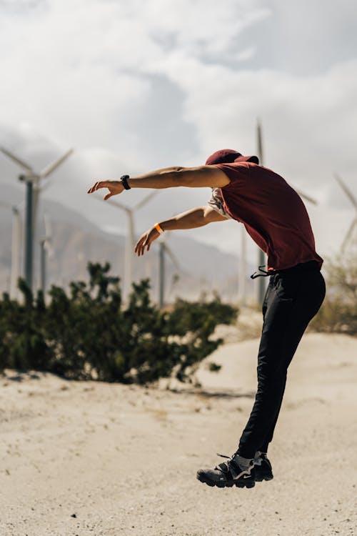 Unrecognizable sportsman jumping on rural road in countryside