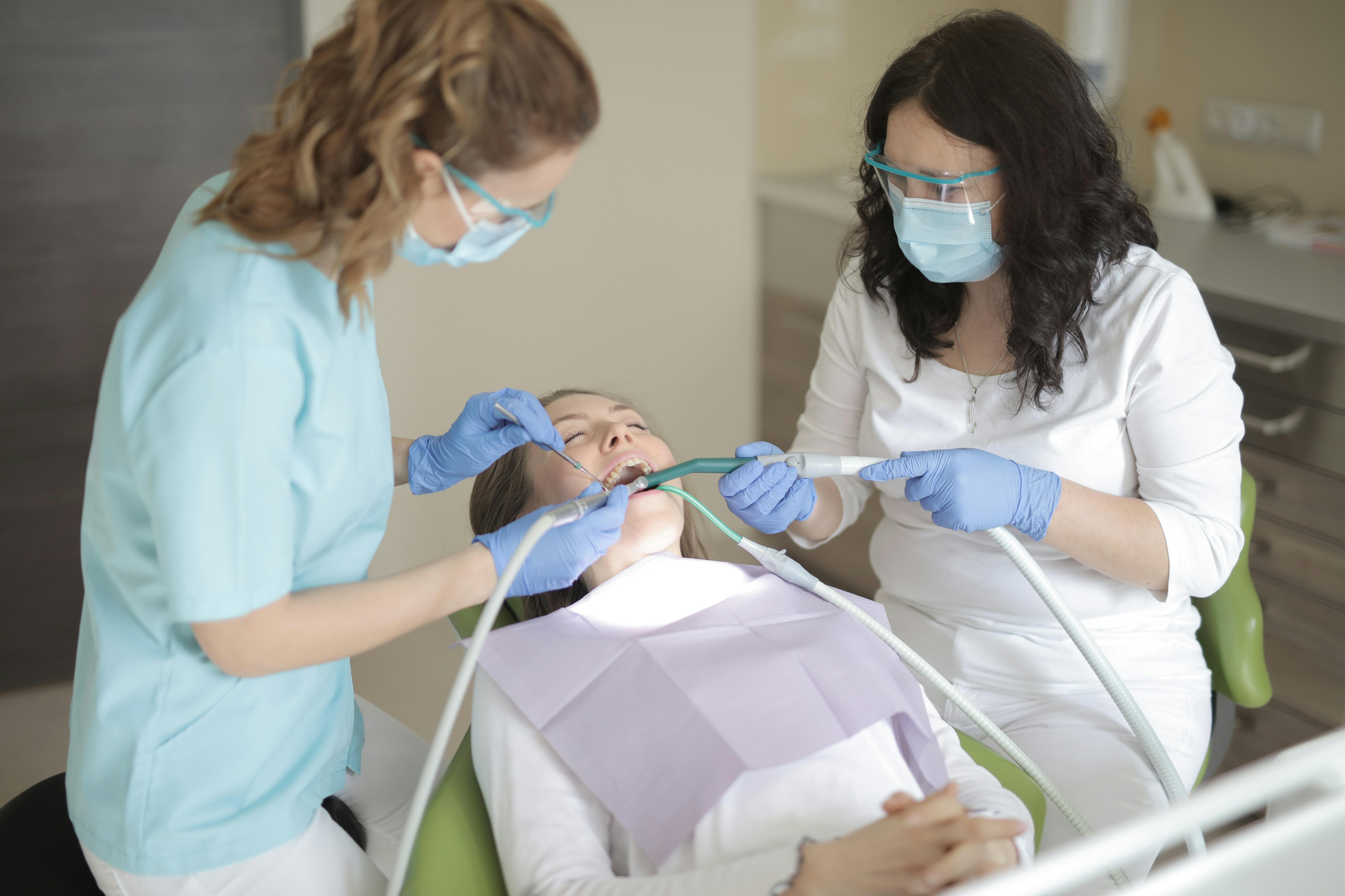 A Dentist Working On Her Patient\u0026#39;s Teeth \u00b7 Free Stock Photo