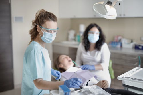 Female Dentist Treating Her Patient