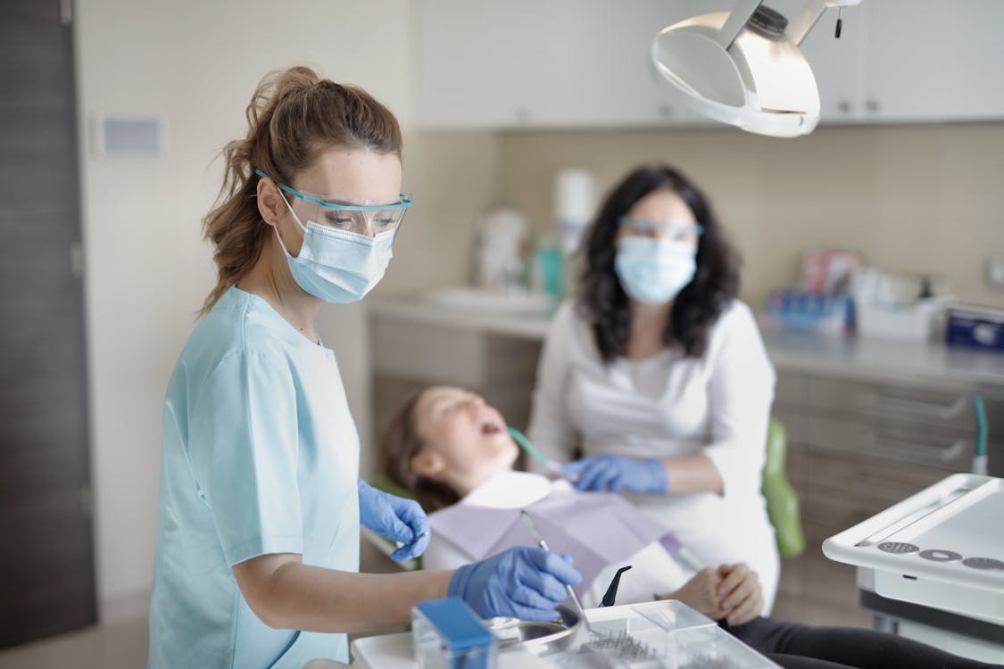 Female Dentist Treating Her Patient