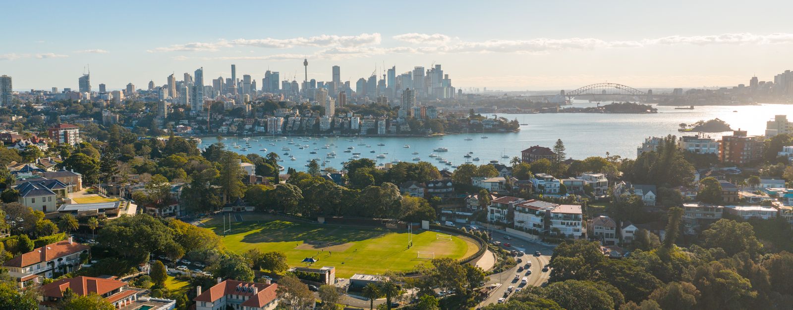 A captivating aerial shot of Sydney skyline with the iconic Harbour Bridge at sunset.