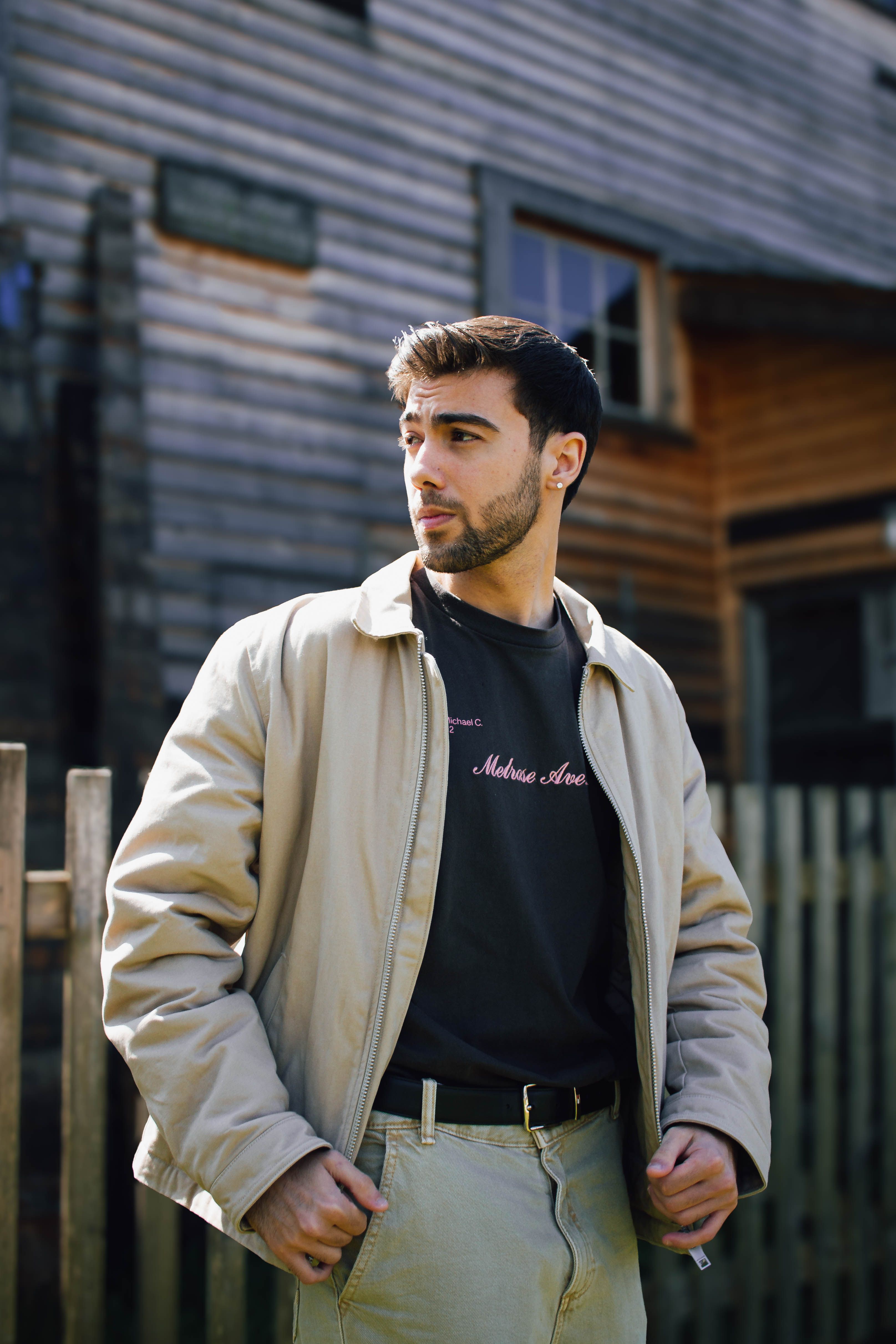 A man in casual attire poses outdoors in Vancouver. Stylish and modern look.