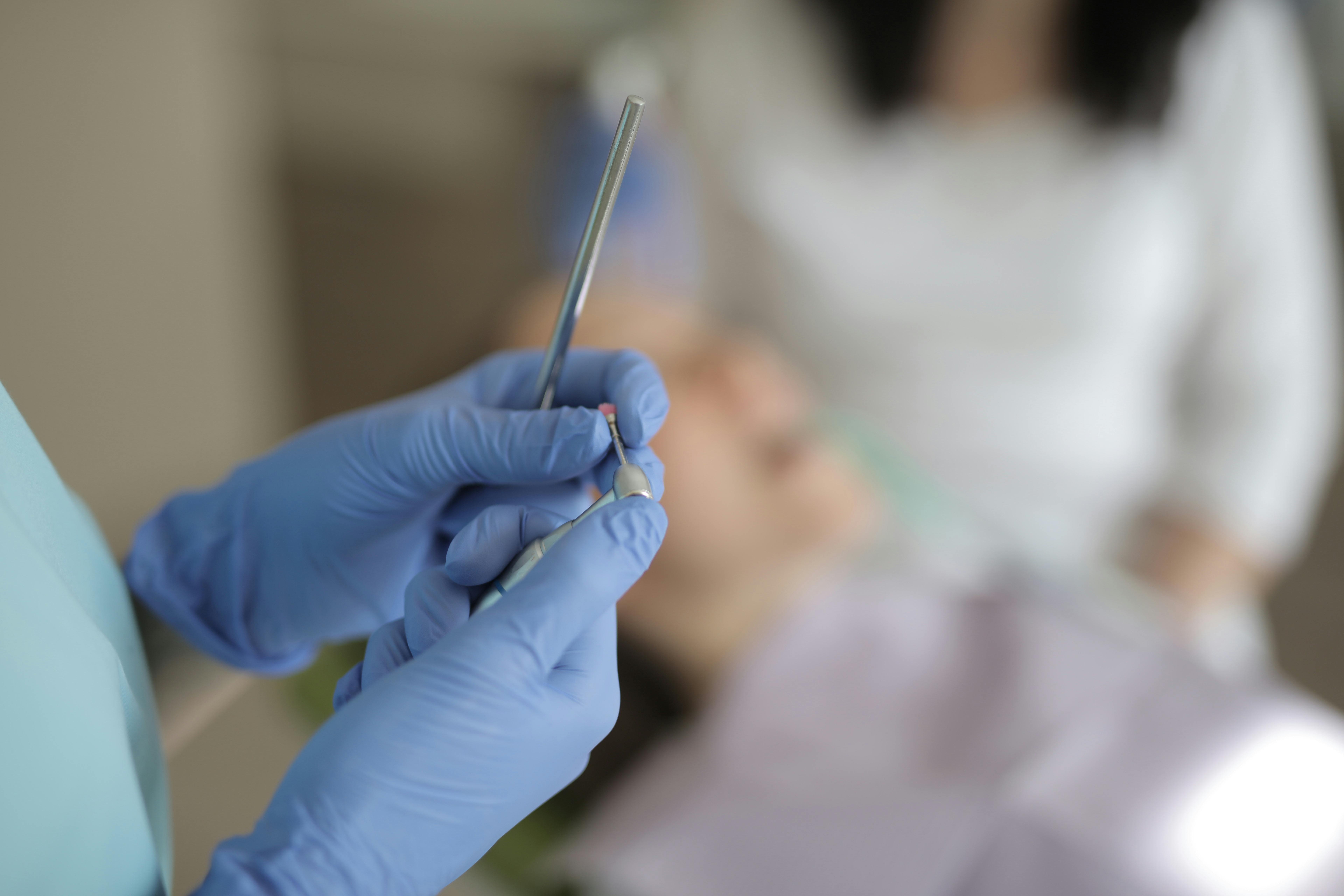 Unrecognizable dentists using medical equipment during teeth treatment in modern clinic \u00b7 Free ...