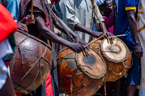 Free A lively outdoor scene with musicians playing traditional African drums, showcasing cultural heritage. Stock Photo