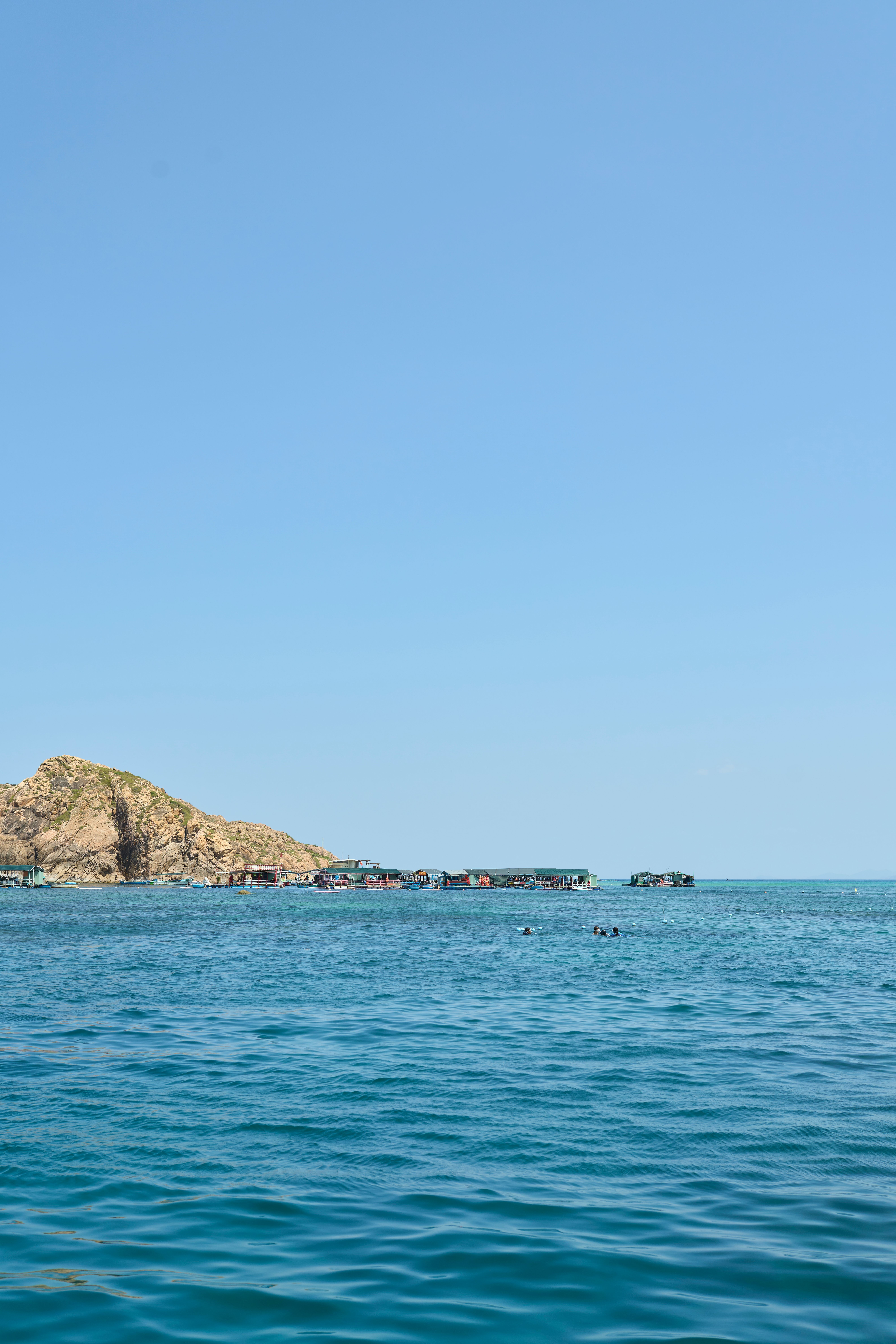 Scenic view of the clear blue waters along Quy Nhơn Đông, Vietnam, with distant islands.