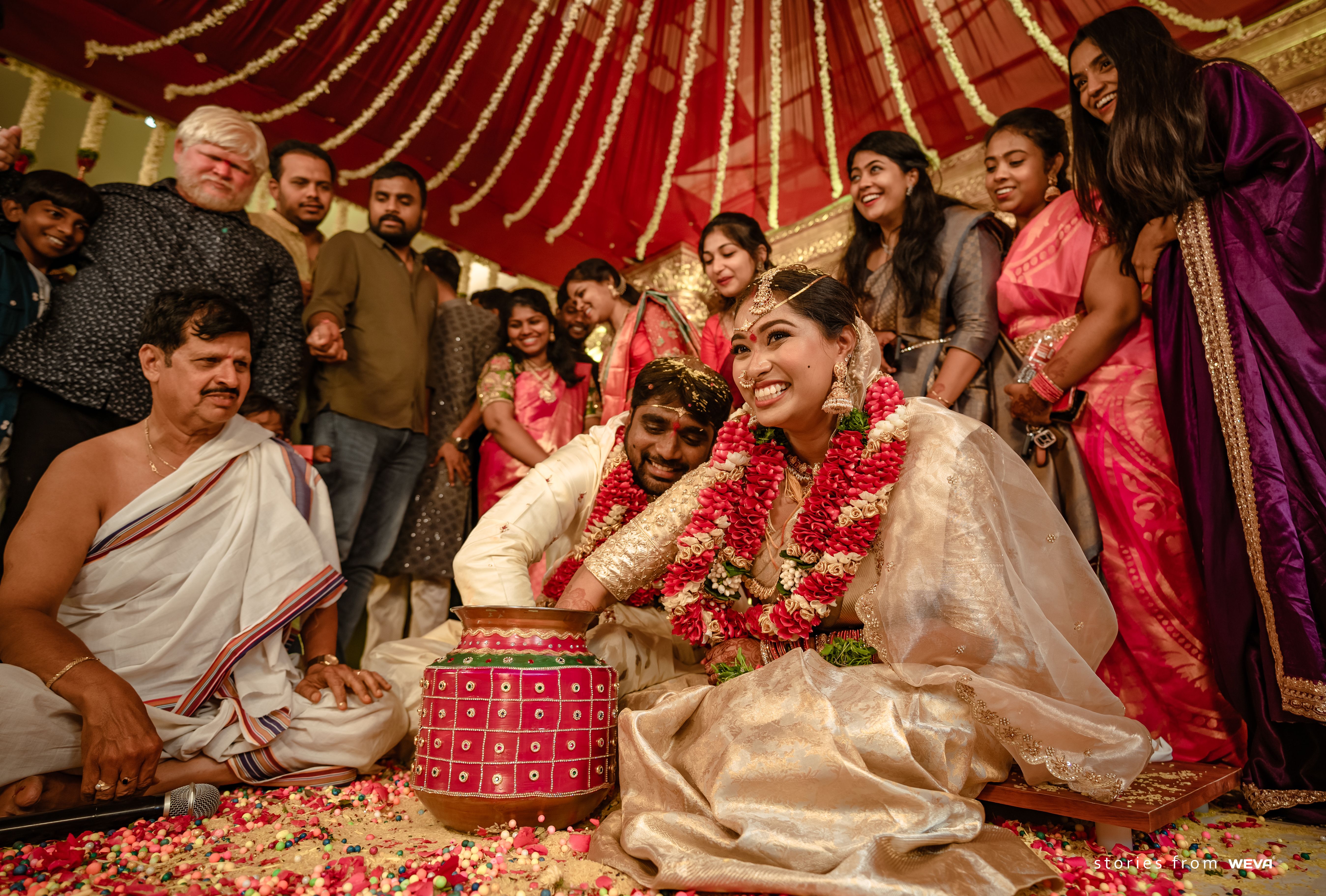 Vibrant South Indian wedding ceremony with happy bride and groom surrounded by family.